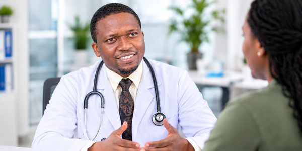 Dr. Solomon Kimera consulting with a patient